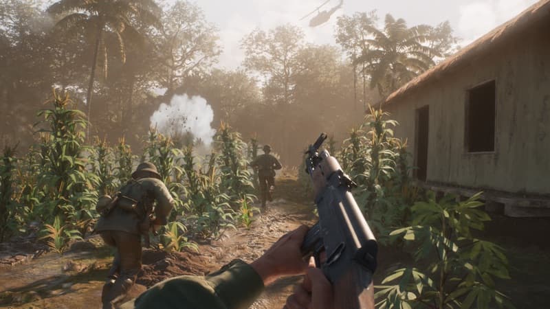 Soldiers moving through a sunlit Vietnamese jungle
